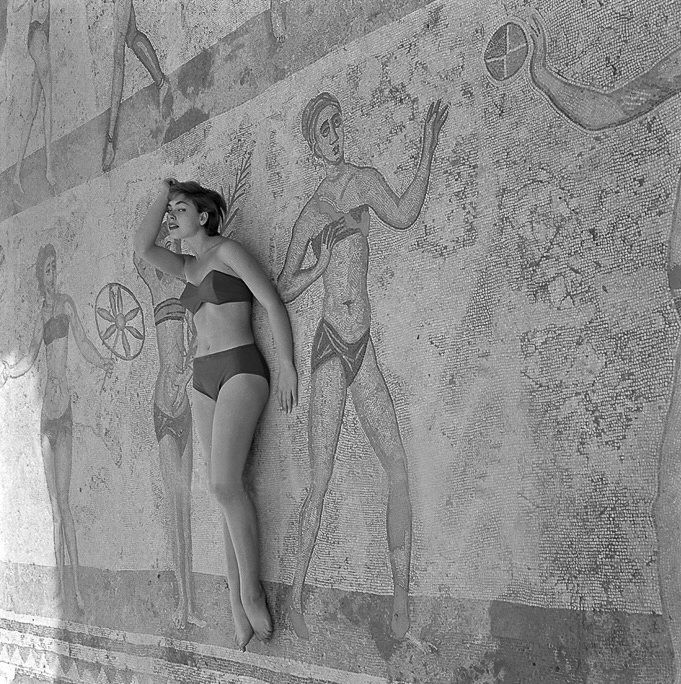A model lays on the bikini girl mosaic in the villa del casale in Sicily in sicily